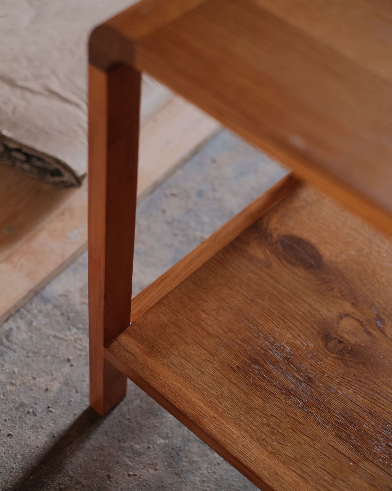 Close-up of a solid timber side table with a lower shelf