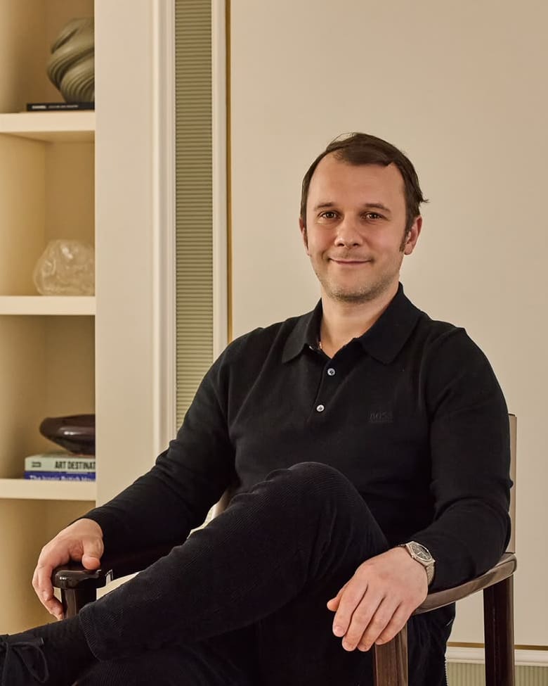 Kirill seated in a leather director's chair