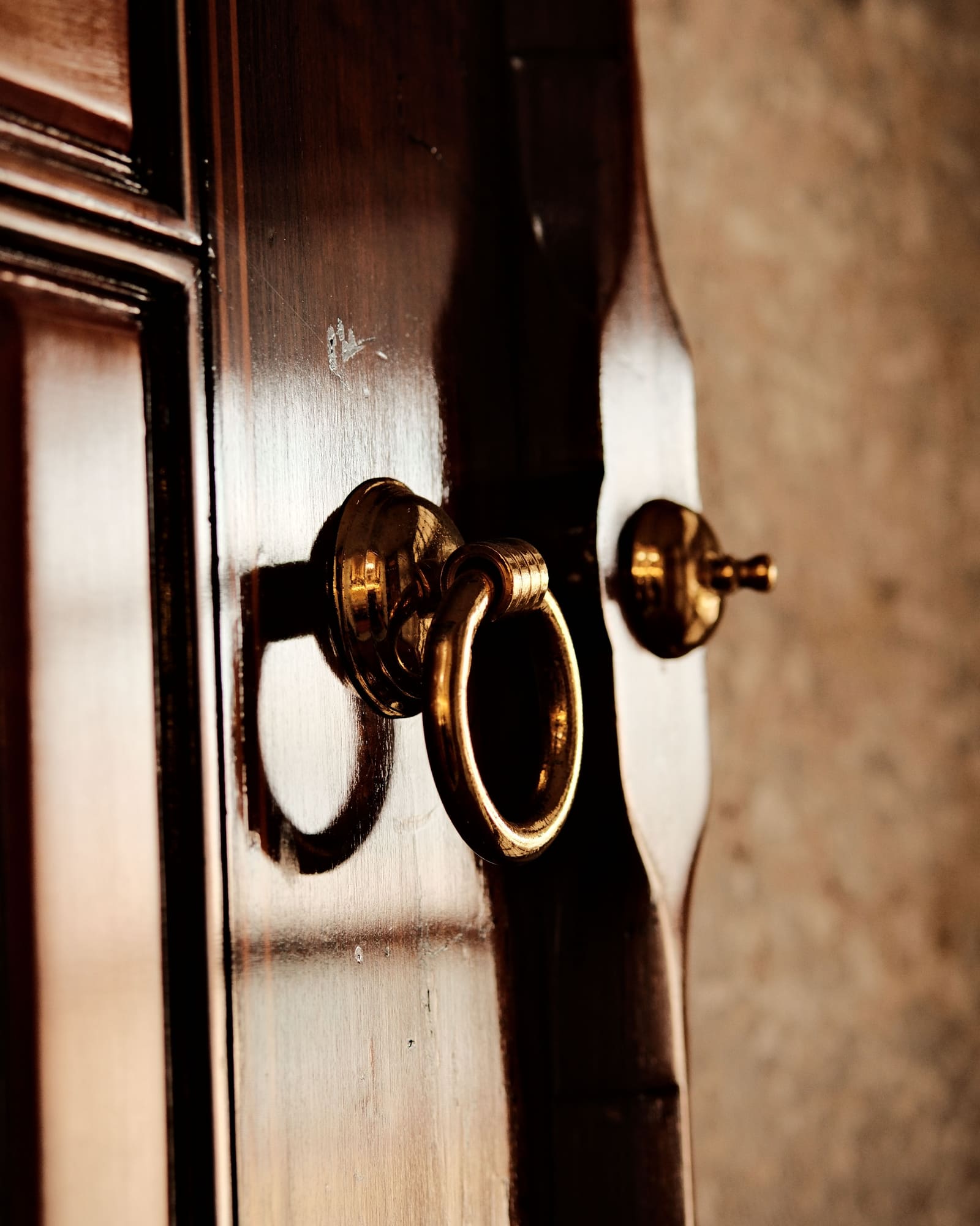 Brass ring pull on a polished timber door